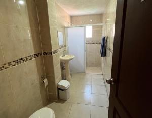 a bathroom with a toilet and a sink and a shower at 2 VENATOR House Boutique in León