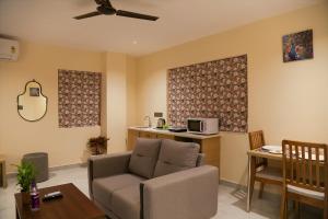a living room with a couch and a table at Lumis studio apartment in Hyderabad