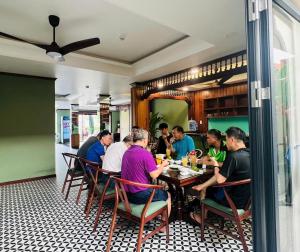 a group of people sitting at a table in a restaurant at Nhã Hotel in Phan Rang–Tháp Chàm