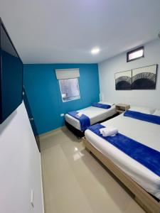 Postel nebo postele na pokoji v ubytování Hotel Select Medellin