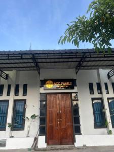 a building with a pumpkin sign above a wooden door at Acc Family Homestay in Takengon +7 photos