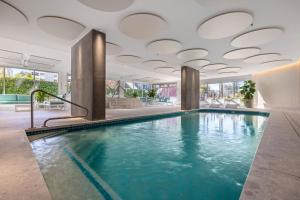 a swimming pool in a hotel with a ceiling at ULTIQA Beach Haven on Broadbeach in Gold Coast