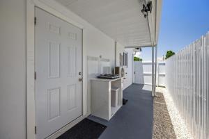 a white garage with a white door and a white fence at Cozy Apartment with a luxury King Bed in Miami Gardens