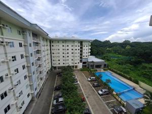 an aerial view of a building with a pool at GEM Condotel by JamYatz homestay Amaia Altaraza in Tunkong Manga
