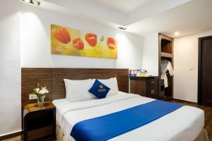 Postel nebo postele na pokoji v ubytování Sandals Lily Hotel