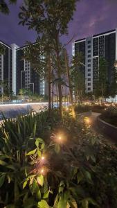 a garden with lights in a city at night at Maya Bay Gamuda Cove Splash Mania near KLIA and Cyberjaya in Pulau Kempas