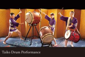 a group of men playing drums on a stage at Yamanaka Onsen Kagari Kisshotei in Kaga