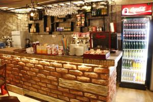 a brick bar in a restaurant with a soda machine at Hotel Ultra Star in Skopje