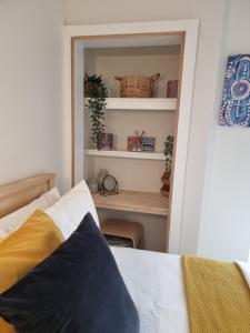 a bedroom with a bed and a desk with shelves at Queen bed apartment- No sharing, your very own space in Quinns Rocks