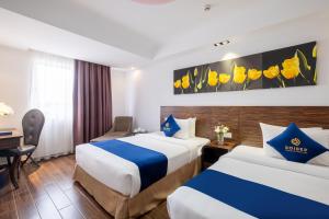 Postel nebo postele na pokoji v ubytování Sandals Lily Hotel