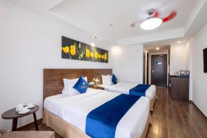 Postel nebo postele na pokoji v ubytování Sandals Lily Hotel
