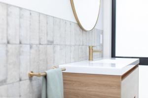a bathroom with a white sink and a mirror at Lakefront Living - Lake Rotoiti Holiday Home in Rotorua