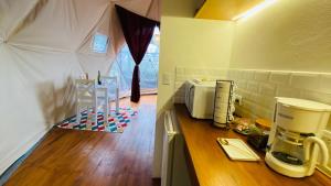 a kitchen with a tent with a coffee maker on a counter at FéLIZA Rainforest Domes in Monteverde Costa Rica