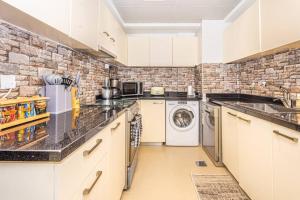 a kitchen with a washer and dryer at Contemporary Full Ocean View Apartment in Ras al Khaimah