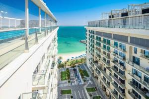 a view of the ocean from the balcony of a building at Contemporary Full Ocean View Apartment in Ras al Khaimah