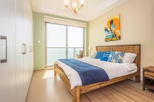 a bedroom with a bed with a view of the ocean at Contemporary Full Ocean View Apartment in Ras al Khaimah +17 photos