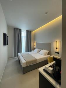 a hotel room with a large bed and a desk at Palladion Boutique Hotel in Argos +49 photos