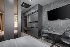 a bedroom with a bed and a tv on a wall at Center Apartments BAG, With PRIVATE FREE PARKING in Pula