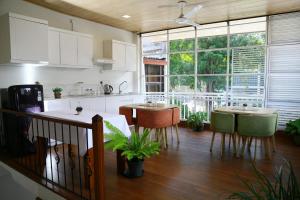a kitchen with two tables and a large window at City Nest Inn in Kandy