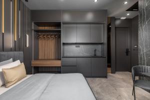 a bedroom with a large bed and a kitchen at Center Apartments BAG, With PRIVATE FREE PARKING in Pula