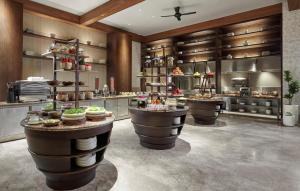 a restaurant with a bunch of food on display at Holiday Inn Resort Bali Canggu by IHG in Canggu
