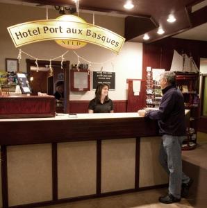 two people standing at a hotel port aux basques counter at Hotel Port Aux Basques in Channel-Port aux Basques
