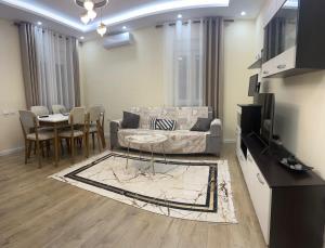 a living room with a couch and a table at B&b Kroni 1 in Shkodër +25 photos