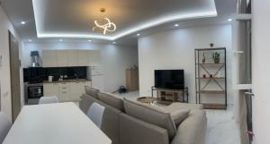 a living room with couches and a kitchen at B&b Kroni 1 in Shkodër