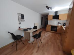 a kitchen with a table and chairs in a room at Haus Blumenampel in Schmalkalden