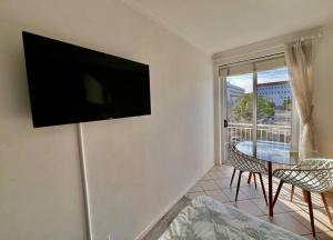 a living room with a flat screen tv on the wall at Escape to 205 in Stellenbosch central-free parking in Stellenbosch