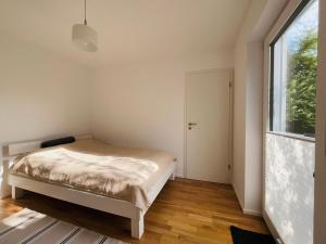 a bedroom with a bed and a large window at Deluxe in Burladingen