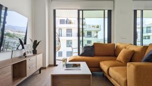 a living room with a couch and large windows at ASTER sweet apartment in Villajoyosa