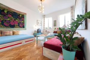 een woonkamer met een bed en een potplant bij Cosy Art Flat 2 in Boedapest