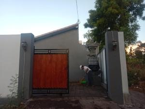 a man is standing in front of a door at Me'Sari Guest House in Karangasem +2 photos