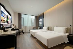 Postel nebo postele na pokoji v ubytování Atour Hotel Foshan Shunde Qinghuiyuan