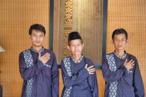 three men standing together with their arms crossed at Villa Bango in Cilember Udik 1
