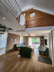 a living room with wooden ceilings and a room with couches at L'escapade Romantique in Dreuil-lès-Amiens +93 photos
