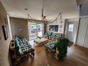 a living room with two couches and a table at L'escapade Romantique in Dreuil-lès-Amiens