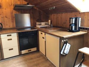 a kitchen with a sink and a stove top oven at Ferienwohnung Zum Eduardstal in Reisenbach +11 photos