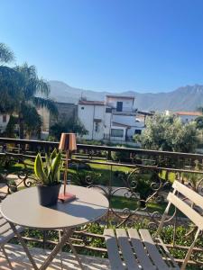 a table and two chairs and a lamp on a balcony at The green leaves in Santa Maria La Carità