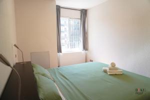 a baby doll sitting on a bed in a hospital room at Chamartin Centro Norte Apartment in Madrid +35 photos