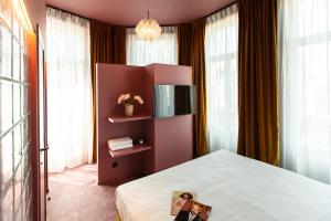 a bedroom with a bed with a picture on it at The Mila Brussels in Brussels