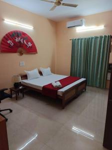 a bedroom with a large bed in a room at Ac 3 Bedroom House Mysore in Mysore