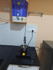 a pot on top of a stove in a kitchen at Ac 3 Bedroom House Mysore in Mysore