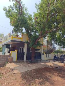 a house with a tree in front of it at Ac 3 Bedroom House Mysore in Mysore +41 photos