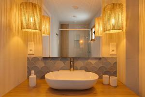 a bathroom with a white sink and a mirror at Under the Spanish Sun - House on the beach in Santa Pola