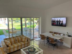 a living room with a couch and a table at Andromeda Shell House in Pefkochori