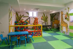 a childrens room with a table and chairs at HOTEL NEST in Bijeljina