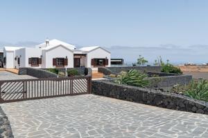 a house with a stone walkway in front of a house at Casa Los Llanos Teseguite Lanzarote in Teguise