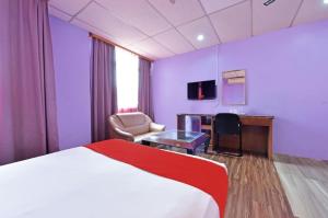 a hotel room with a bed and a desk at Akasia Hotel in Bedung